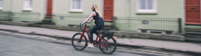 bike-shop-sevenoaks Woman riding on a red electric bike by Wisper Bikes